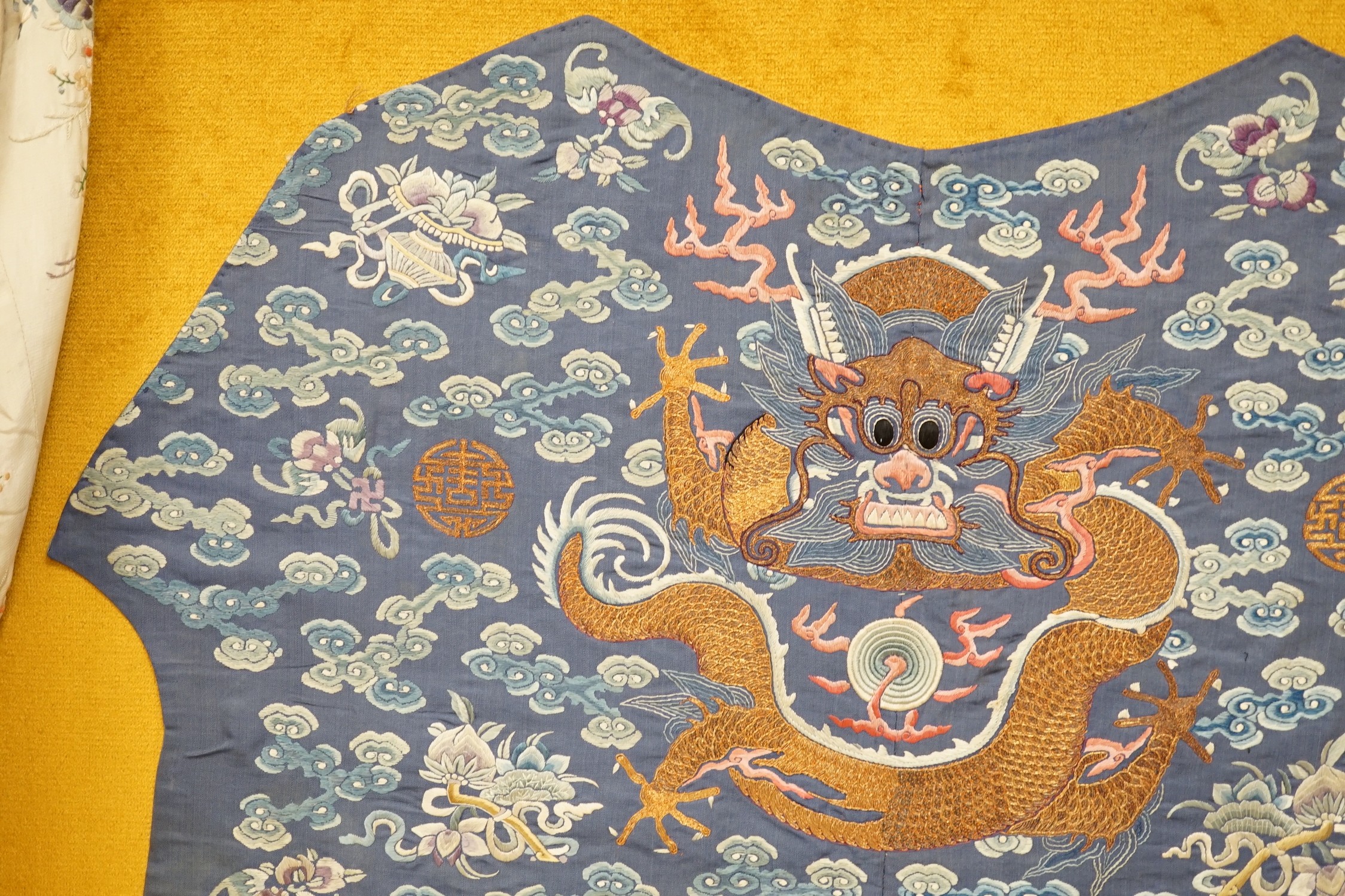 An early 20th century Chinese silk embroidered panel, from a robe, embroidered in metallic and coloured threads as dragons and auspicious symbols